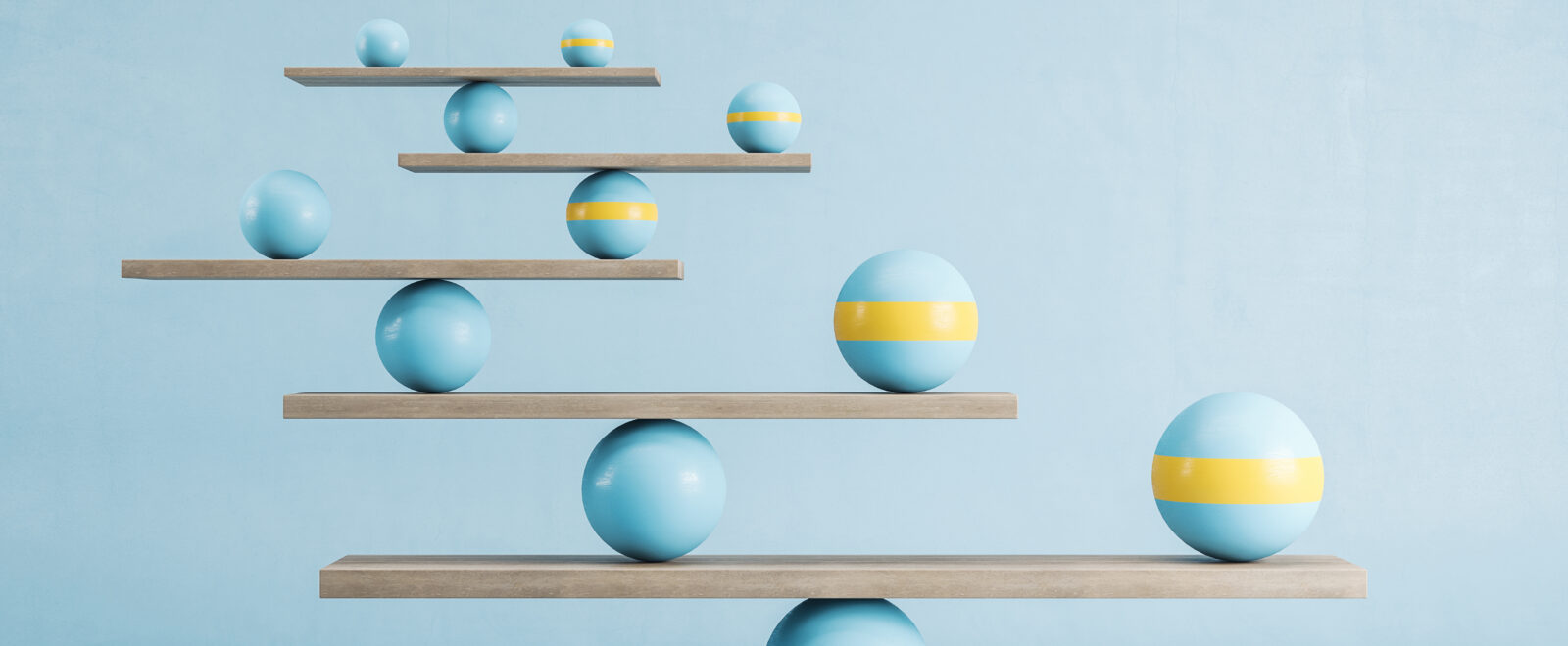 Blue and yellow balls balanced on wooden platforms