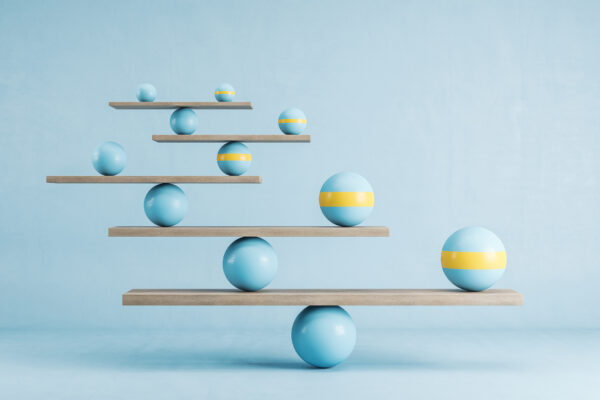 Blue and yellow balls balanced on wooden platforms