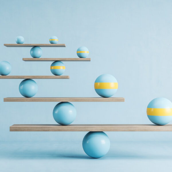 Blue and yellow balls balanced on wooden platforms