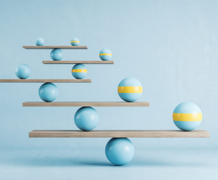 Blue and yellow balls balanced on wooden platforms