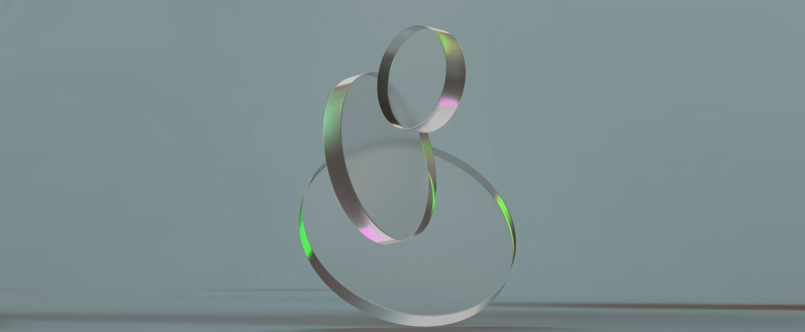 3D rendered round shapes in transparent material on a light back