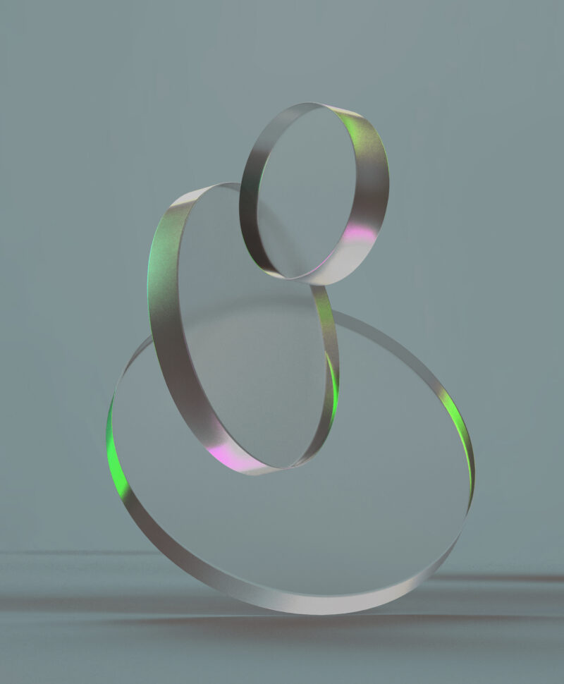 3D rendered round shapes in transparent material on a light back