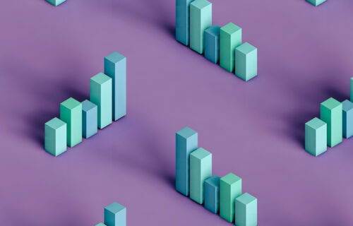 Three dimensional render of pastel coloured bar graphs on purple background