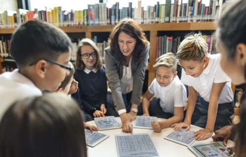 Teacher and children using technology in the classroom