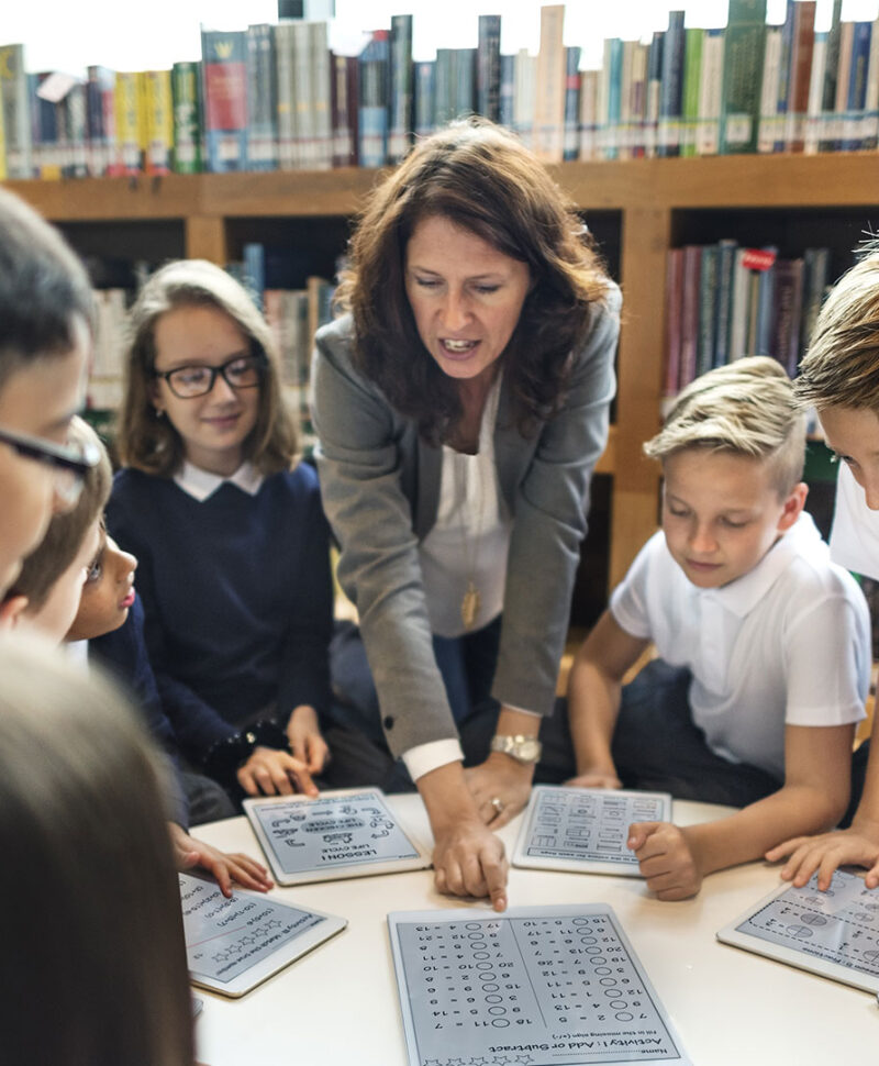 Teacher and children using technology in the classroom