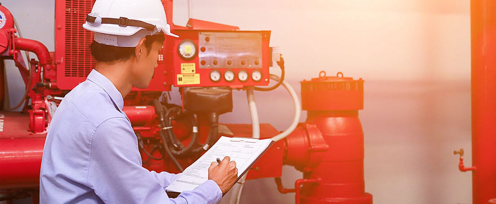 Engineer inspecting fire safety equipment