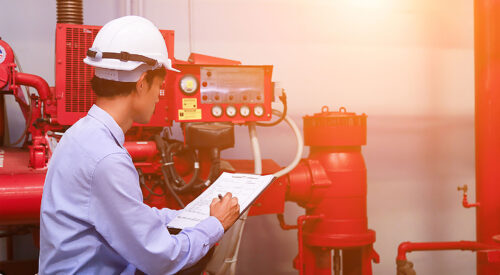 Engineer inspecting fire safety equipment