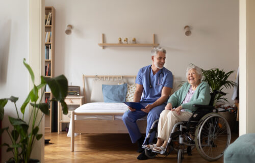 Carer giving healthcare services to an elderly lady in her own home