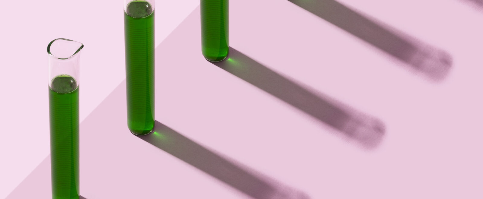 Row of test tubes with liquid, pink background