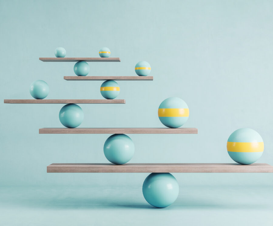 Scales with green and yellow balls on green background.
