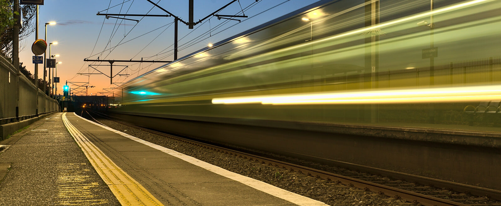 railway station and colorful sky at Blackrock in the evening, Dublin, Ireland. Long exposure shot of the coming train